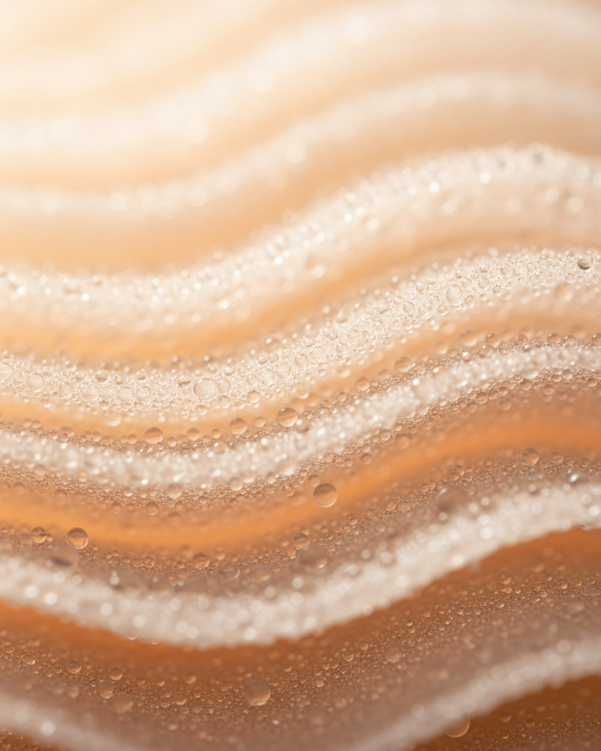 Water droplets beading on a translucent, layered membrane surface lit softly from behind